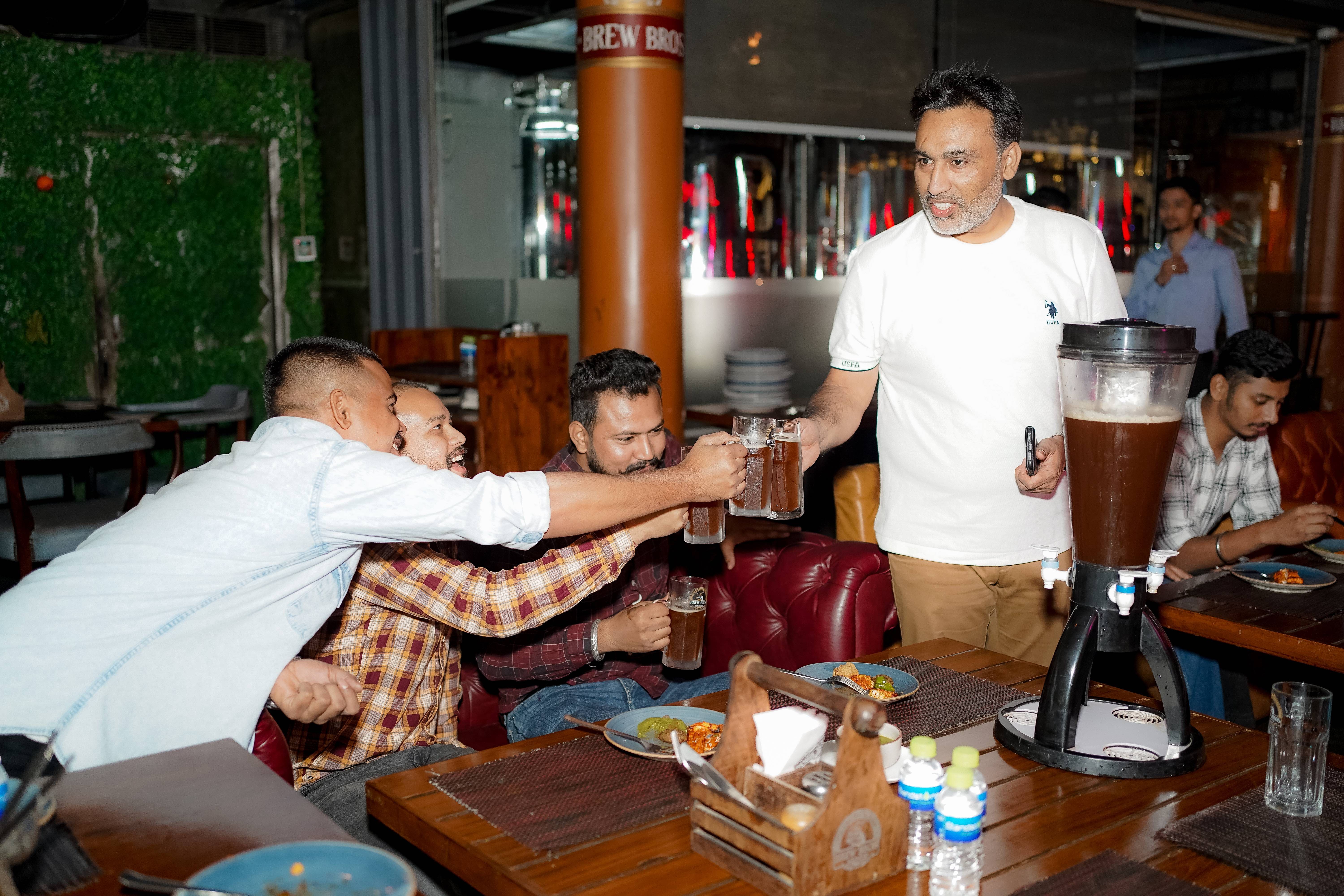 Whizcamp colleagues toasting drinks during a team celebration at Brew Bros